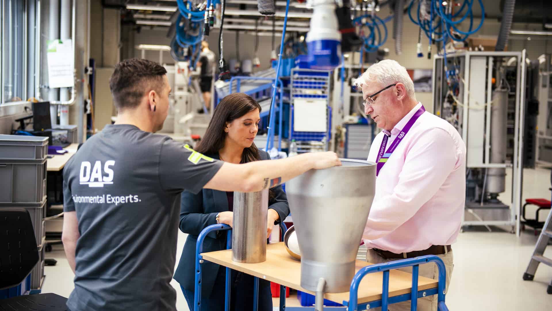 three employees of DAS EE are looking at a part of a waste gas treatment system 